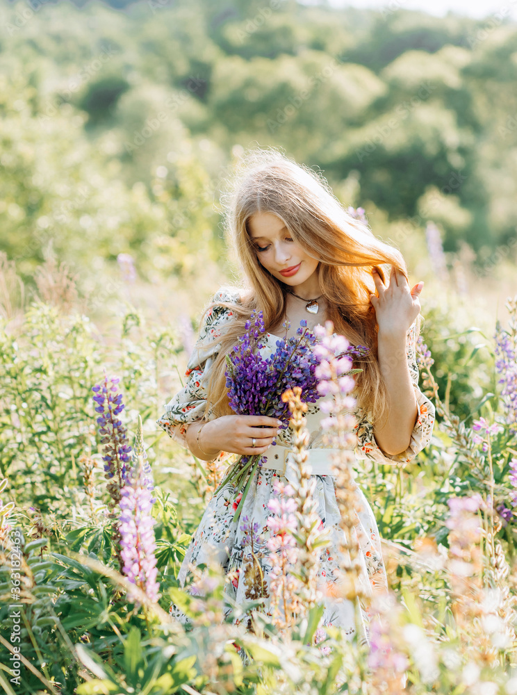 Amazing cute woman in lupine field, sunny day, freedom concept Amazing cute woman in lupine field, sunny day, freedom concept