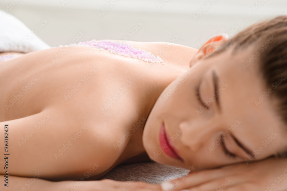 Closeup of calm young woman enjoying sea salt massage Closeup of calm young woman enjoying sea salt massage