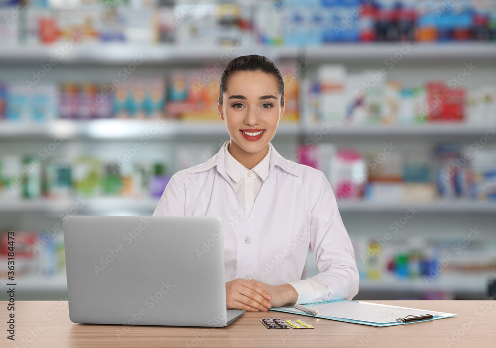 Professional pharmacist working at table in modern drugstore Professional pharmacist working at table in modern drugstore