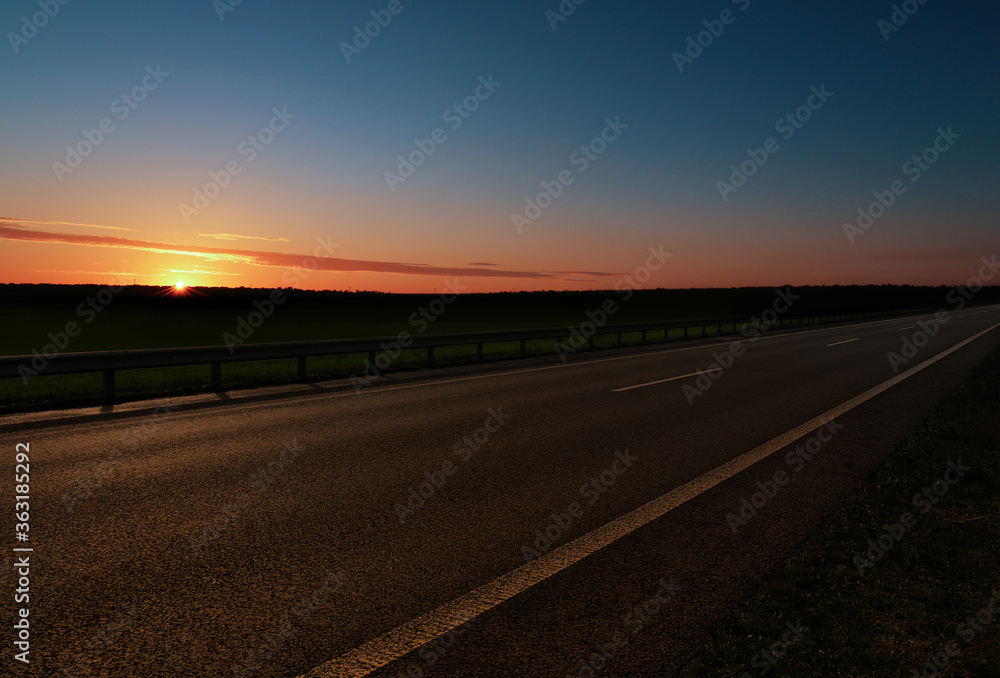 Road trip. Beautiful view of asphalt highway at sunset