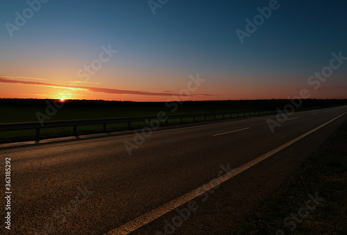 Road trip. Beautiful view of asphalt highway at sunset