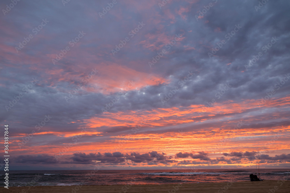 Fototapeta premium fisherman on the beach at sunset