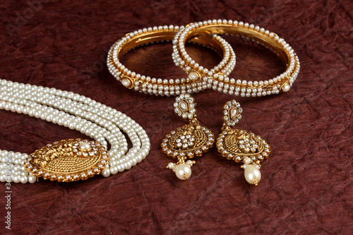 Pearl Jewelry on a textured background, Pearl bracelet, pearl necklace, pearl earrings, Style, fashion and design of jewelry. indian traditional jewellery,jewelry background