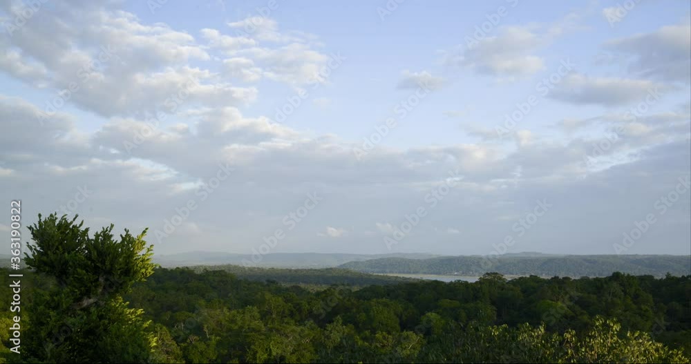 White fluffy clouds rolling on blue sky over the green sea of Yaxa National Park and Nature Reserve in Peten, Guatemala White fluffy clouds rolling on blue sky over the green sea of Yaxa National Park and Nature Reserve in Peten, Guatemala
