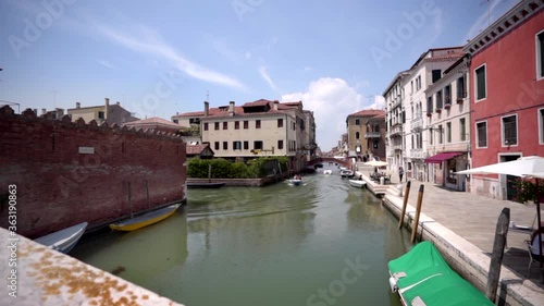 Wallpaper Mural Two men in a boat sail in canal. Venice Italy Torontodigital.ca