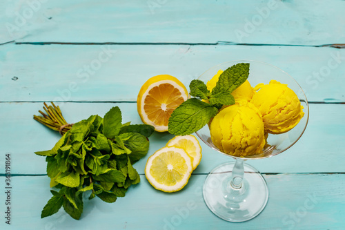 Lemon ice cream with mint. Refreshing summer dessert, ripe fruit, fragrant leaves
