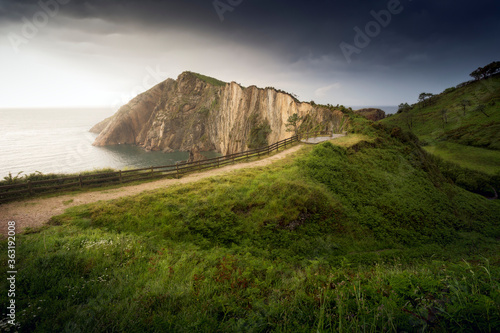 Path to the sea. Horizontal picture of a landscape, with a zigzagging road to the coast. "Playa del Silencio", Asturias, Spain 