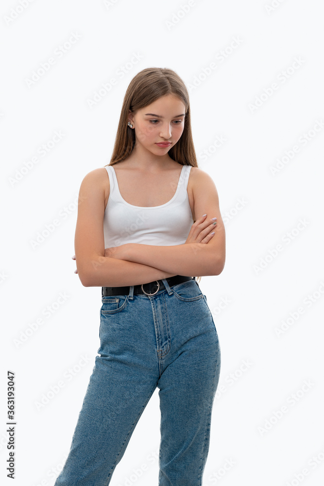 Studio shot of young upset girl teenager with cross arms, isolated Studio shot of young upset girl teenager with cross arms, isolated