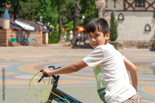 Shot of a young boy with a bicycle outdoors on vacation
