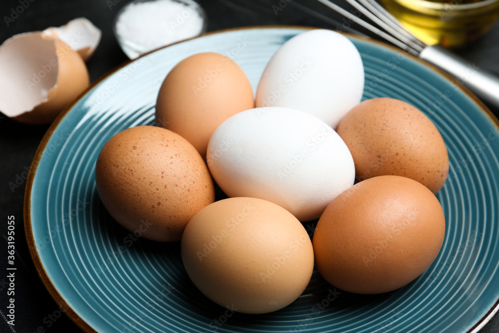 Different chicken eggs on blue plate, closeup Different chicken eggs on blue plate, closeup
