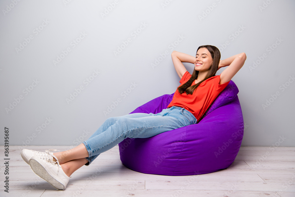 Portrait of her she nice attractive lovely pretty cheerful cheery straight-haired girl lying on bag chair resting light grey pastel color wall room Portrait of her she nice attractive lovely pretty cheerful cheery straight-haired girl lying on bag chair resting light grey pastel color wall room