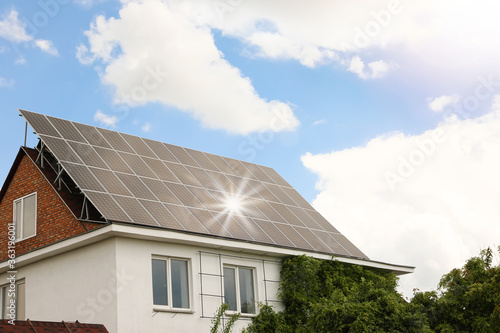 Wallpaper Mural Building with installed solar panels on roof. Alternative energy source Torontodigital.ca