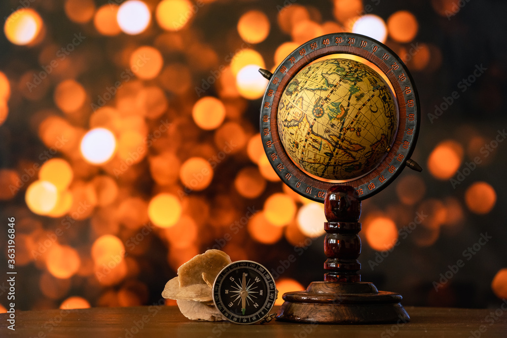 Antique wooden globe map and a compass. Antique wooden globe map and a compass.