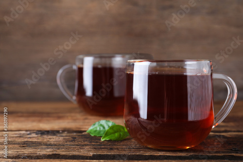 Tasty black tea on wooden table. Space for text