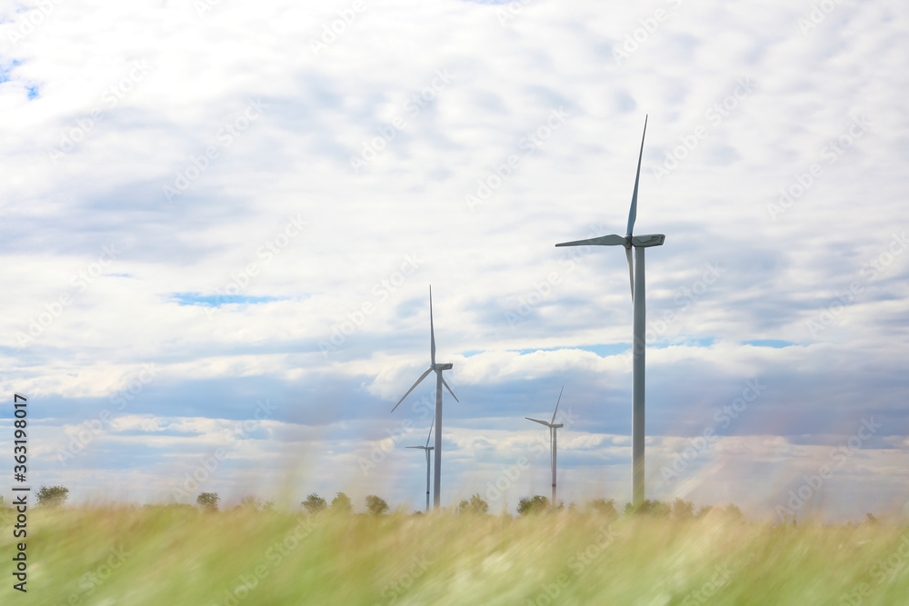 Beautiful view of field with wind turbines. Alternative energy source Beautiful view of field with wind turbines. Alternative energy source