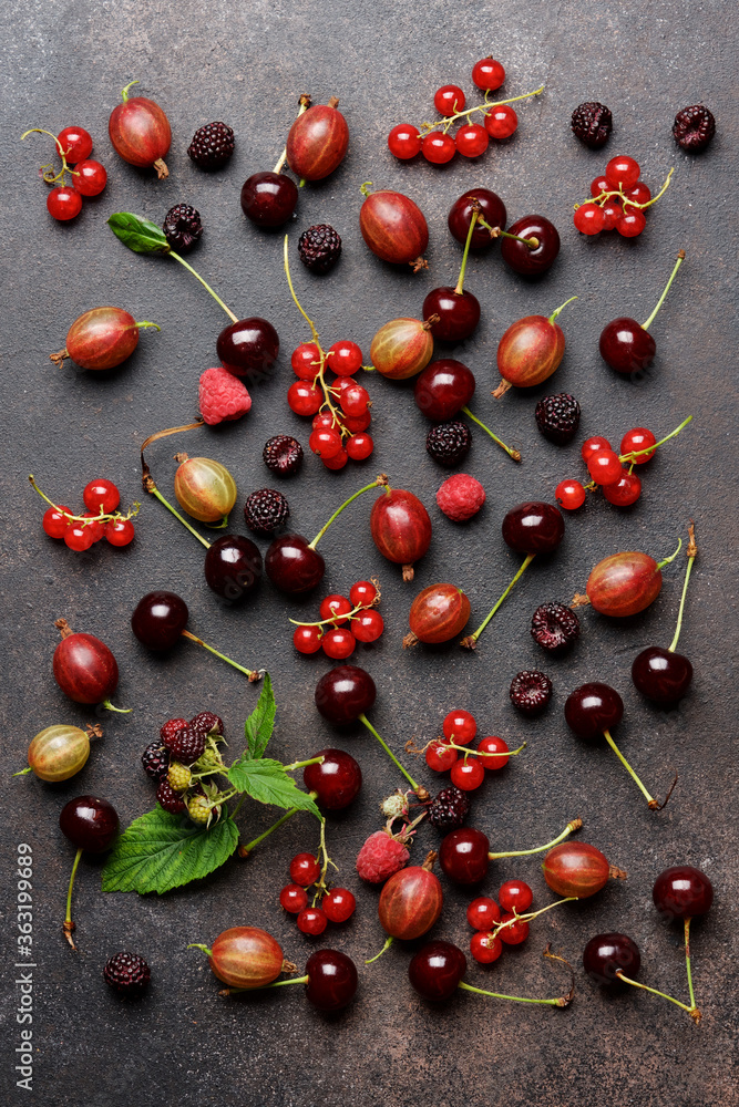 Ripe bright berries on brown background. Redcurrant, cherry, gooseberry, blackberry Ripe bright berries on brown background. Redcurrant, cherry, gooseberry, blackberry