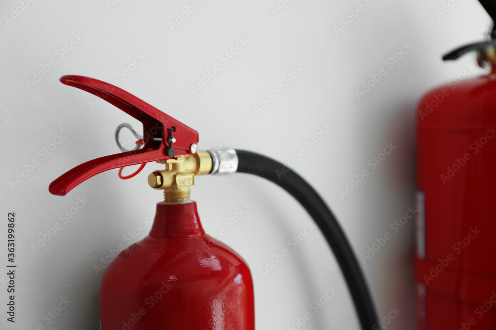 Fire extinguisher on white background, closeup view Fire extinguisher on white background, closeup view