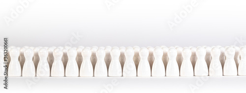 many white wooden figurines in a row