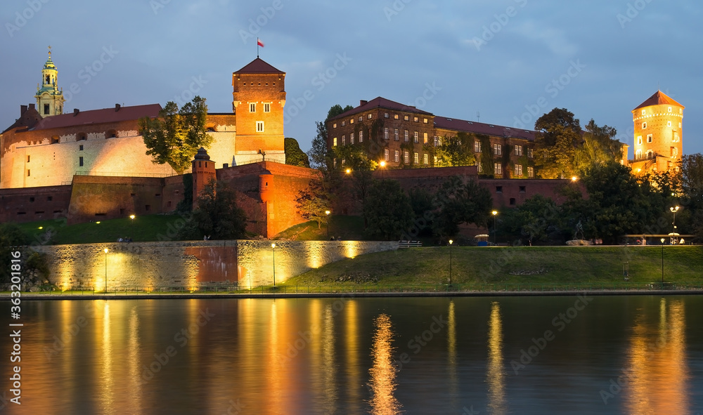 Fototapeta premium Wawel Castle lit up at night viewed from across the River Vistula.