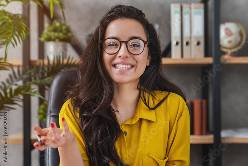 Konstfotografi Head shot of young female employee talk on video call with colleague, consult cl