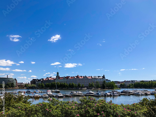 Eläintarhanlahti bay in Tokoinranta in Helsinki. Port with the pier and small moored boats on the background of historic facades of houses. Capital of Finland. Europe.