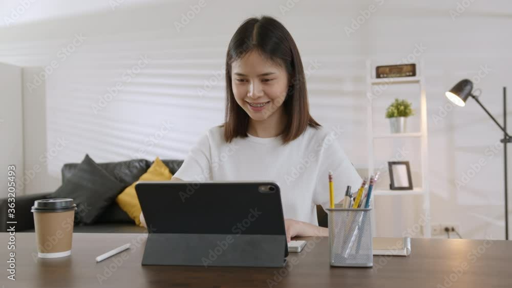 Young Asian woman using digital tablet and video call with learning online on internet. chatting with teacher. Young Asian woman using digital tablet and video call with learning online on internet. chatting with teacher.