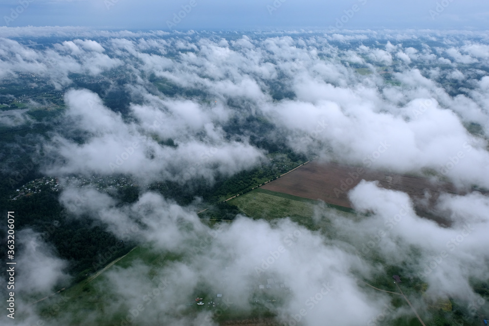 Nature. Clouds in the sky above the earth. View from above.