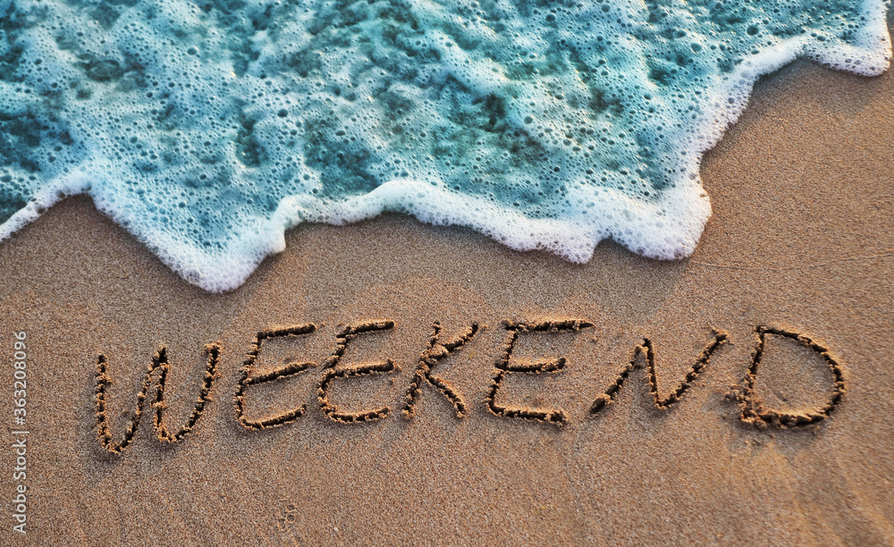 The word weekend written on sand. Sunset beach. Summer background ...