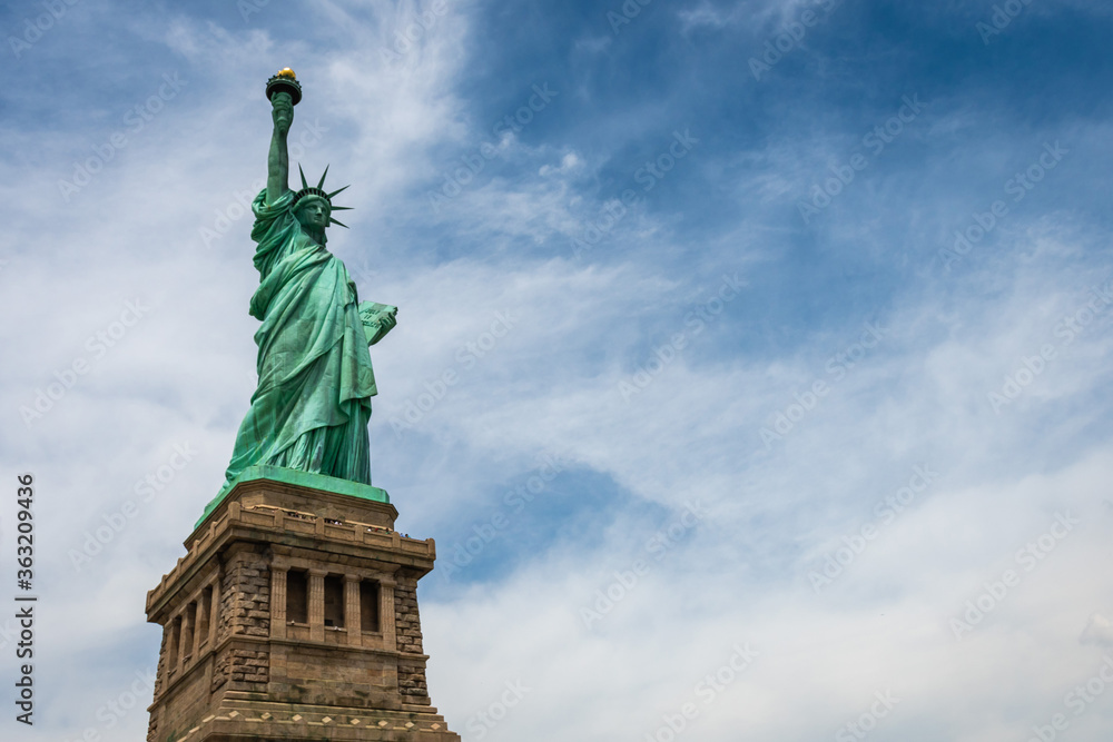 Fototapeta premium Statue of Liberty on Liberty Island closeup with blue sky in New York City Manhattan - Image