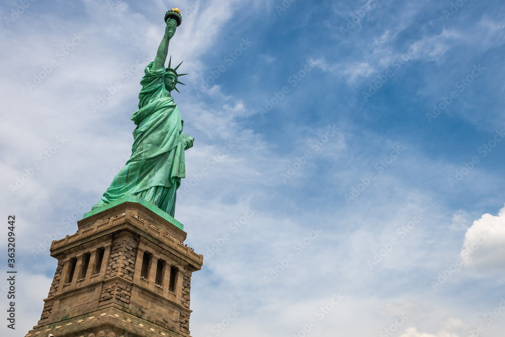 Obraz premium Statue of Liberty on Liberty Island closeup with blue sky in New York City Manhattan - Image