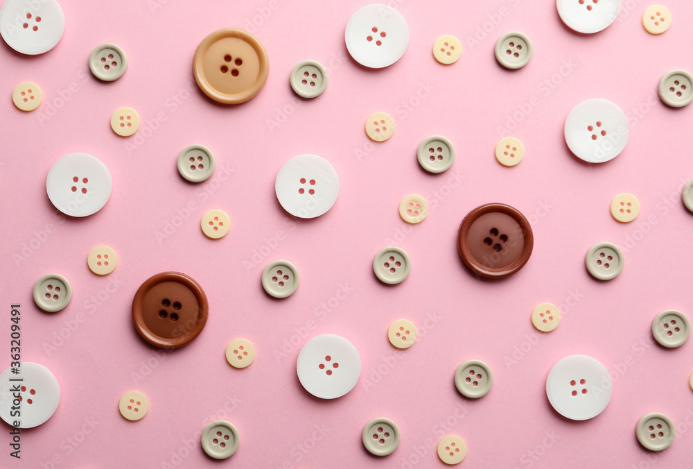 Different sewing buttons on pink background, flat lay Different sewing buttons on pink background, flat lay