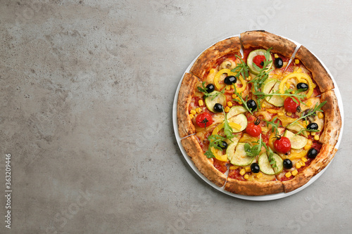 Delicious vegetable pizza on grey table, top view. Space for text