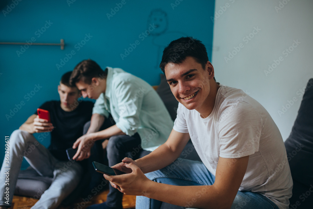 Fototapeta premium teenagers using mobile phone at home
