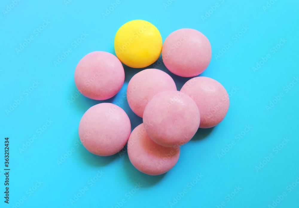 vitamins pills laid out in the shape of an abnormal flower on a blue background vitamins pills laid out in the shape of an abnormal flower on a blue background