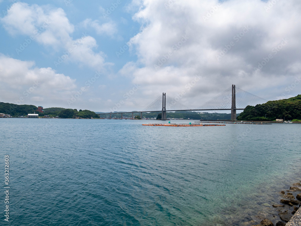 Yobuko bridge passes the sea behind fish pens in Saga prefecture, JAPAN.