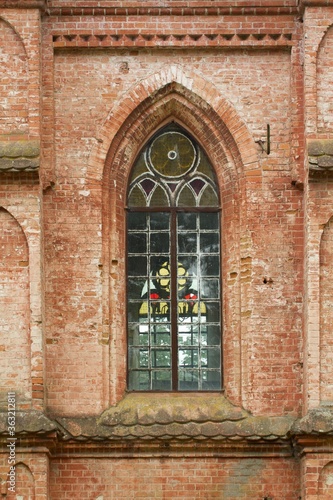 Vintage window. Old red brick church 