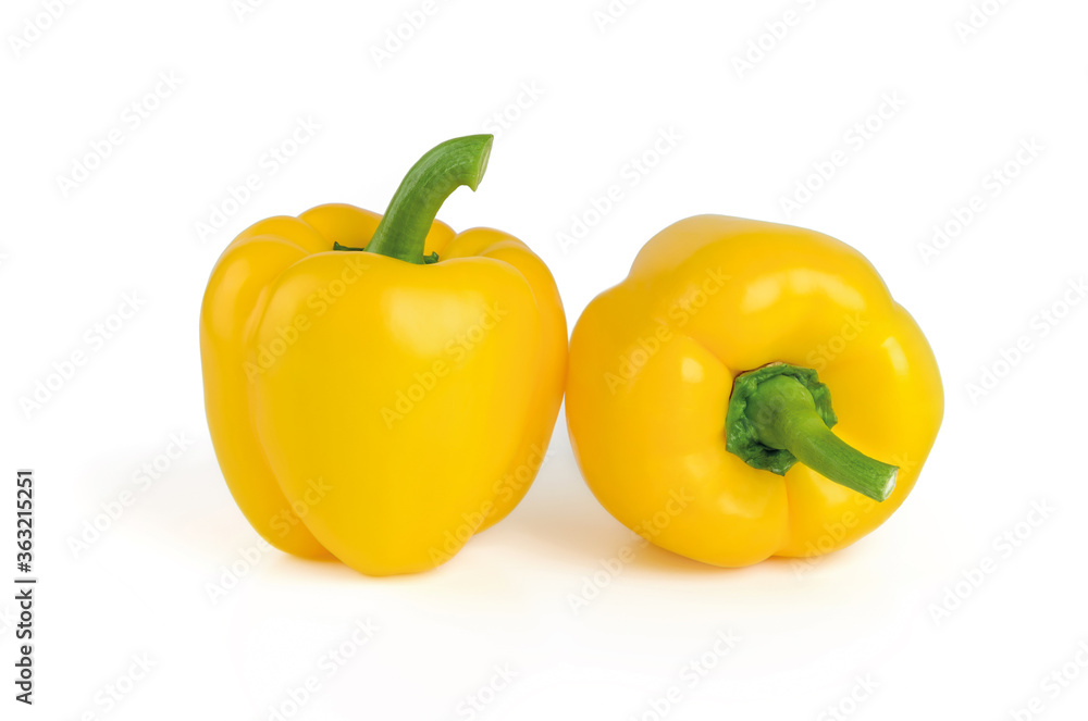 Two whole ripe yellow bell peppers isolated on a white background. Fresh ruits and vegetables, vegetarian food, raw food diet. Two whole ripe yellow bell peppers isolated on a white background. Fresh ruits and vegetables, vegetarian food, raw food diet.