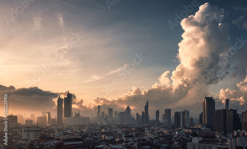 Sunrise over Bangkok city with high buildings in business district and dramatic sky
