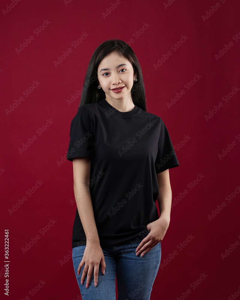 Front view white t-shirt Closeup on female body, woman girl in empty black t-shirt isolated on red background. Design woman t-shirt template and mockup for print. Front view white t-shirt Closeup on female body, woman girl in empty black t-shirt isolated on red background. Design woman t-shirt template and mockup for print.