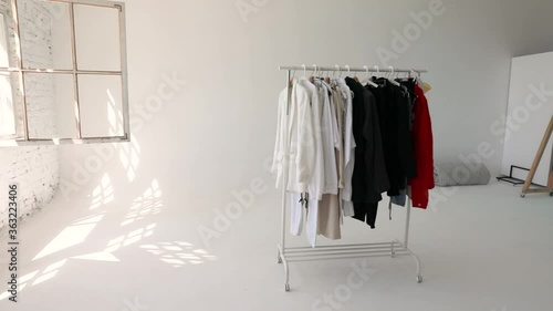 Wallpaper Mural Wardrobe rack with stylish clothes near white wall indoors. Space for text Torontodigital.ca