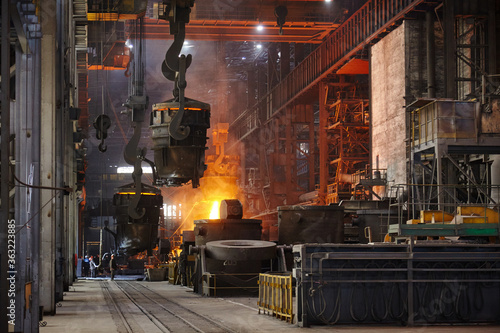 Steelmaker at ingot casting. Electric arc furnace shop EAF. Metallurgy.