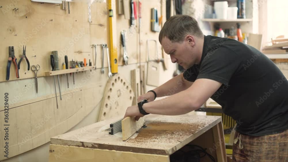 A man works on a milling machine A man works on a milling machine