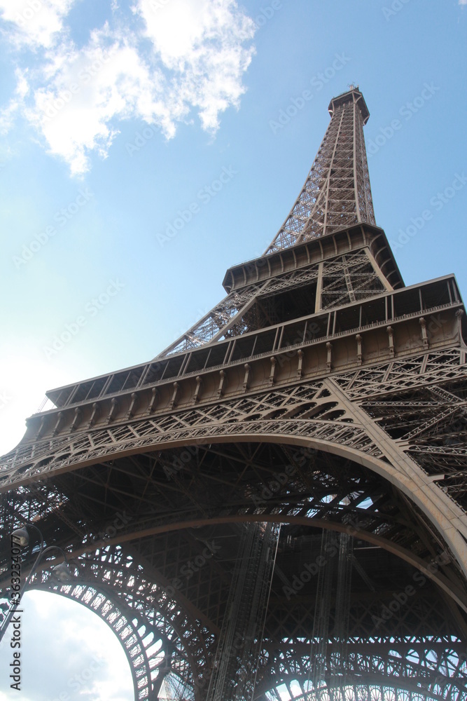 The iconic Eiffel Tower of Paris (wrought-iron lattice tower) against clear blue skies