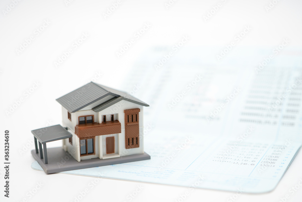 The house model is placed on bank notes. Investing in investment in real estate Home loan using as background business concept and real estate concept with copy space for your text The house model is placed on bank notes. Investing in investment in real estate Home loan using as background business concept and real estate concept with copy space for your text