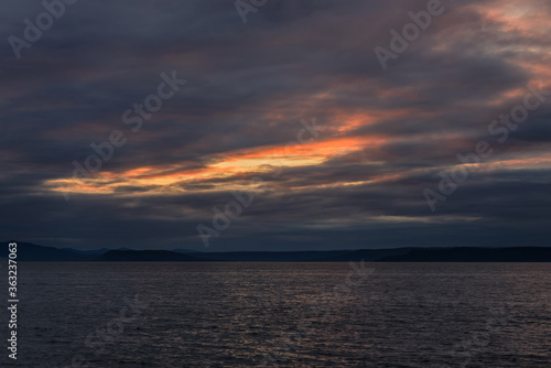 Beautiful sunset with clouds and sea. © Vladimir Arndt