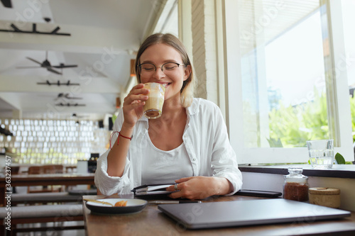 Wallpaper Mural Business. Woman Drinks Coffee At Cafe. Happy Stylish Girl In Glasses With Laptop And Planner Book Enjoying Latte. Digital Technologies For Remote Work Or Online Studying At Comfortable Place.  Torontodigital.ca