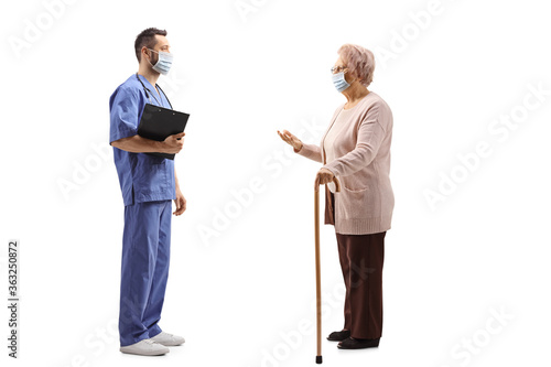 Elderly woman talking to a medical worker with a face mask