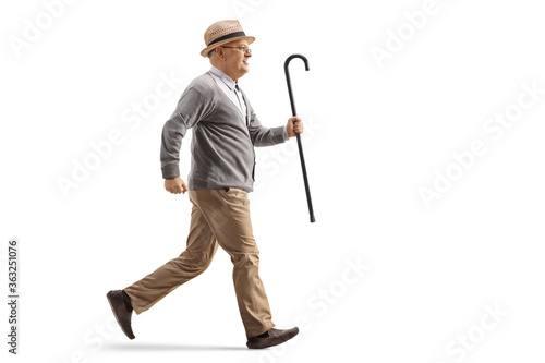 Elderly man running and holding a walking cane