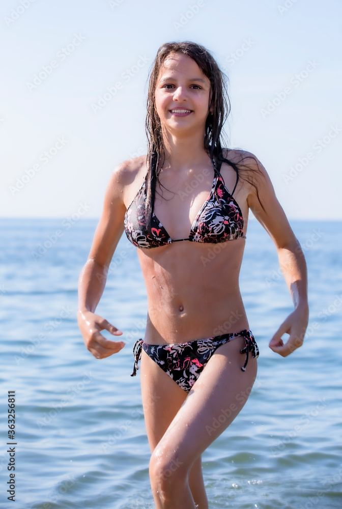 Beautiful girl with long hair resting on a sandy beach a summer day Beautiful girl with long hair resting on a sandy beach a summer day