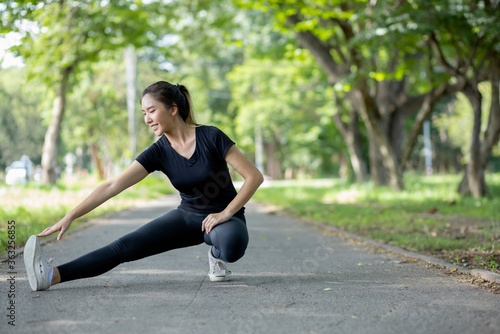 Asian women are stretching their muscles before going out to run to the park to keep themselves healthy and have beautiful puppets.